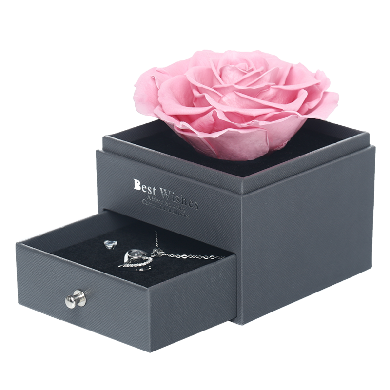 single pink rose in jewelry box